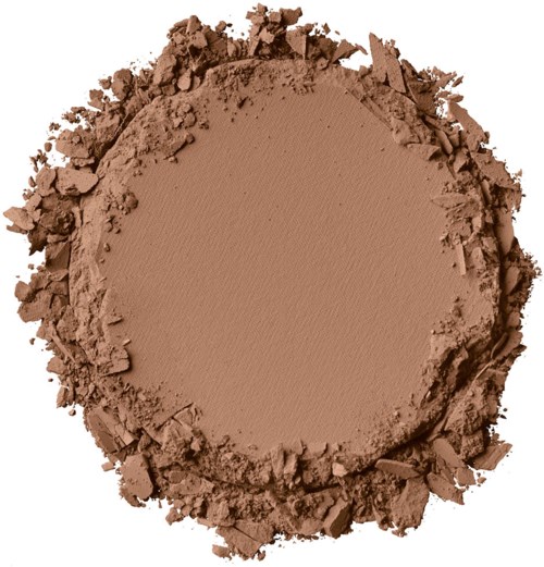 En rund klump av brunt pulver, omgiven av lösa bitar, kanske makeup eller lera.