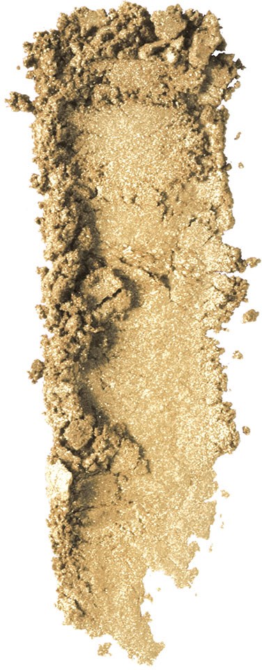 Ett beige pulver spritt ojämnt, med några klumpar och en glittrig, ljus mitt.