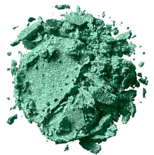 Crushed green powder, likely makeup or eyeshadow, with some larger broken pieces and fine dust around.