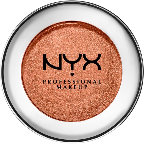 A round makeup product with a peachy, shimmery color. NYX Professional Makeup logo is on the surface.
