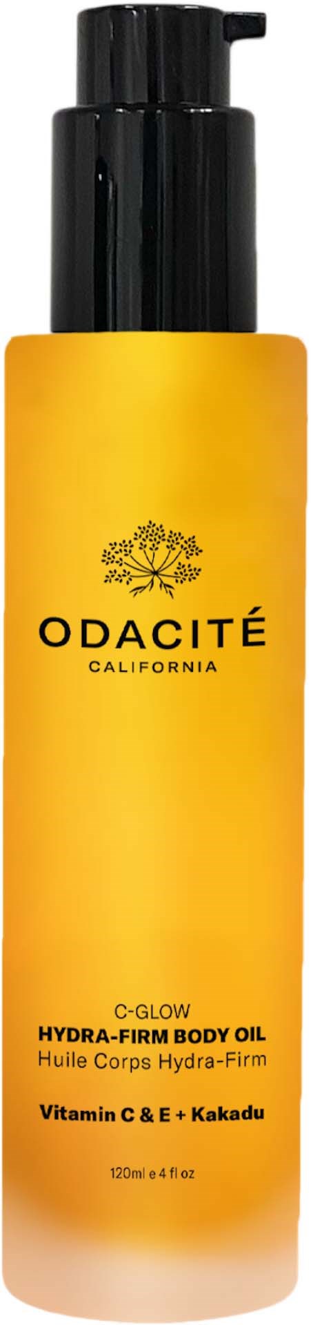 A yellow body oil bottle labeled Odacité California, with black pump and product details at the bottom.
