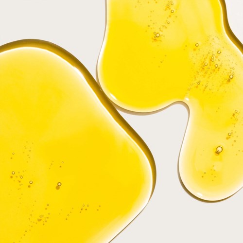 Two yellow, irregularly shaped blobs with bubbles inside, on a white background.