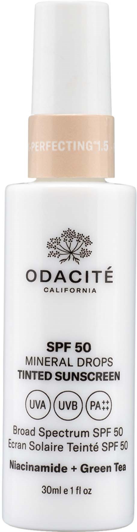 En hvit flaske med Odacité solkrem med pumpe, merket SPF 50, med grønn te og laget i California.