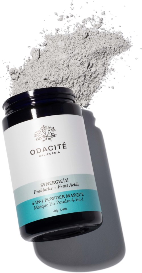 A black container with white and blue label, spilled powder on a white background.