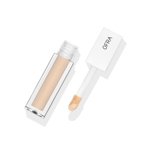 Pieni beige säilö, jossa on valkoinen laru ja etiketti "OFRA".