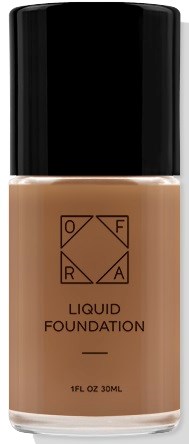 En flaska flytande foundation, en makeupprodukt, med svart lock och beige färg, märkt med varumärke och produktdetaljer.
