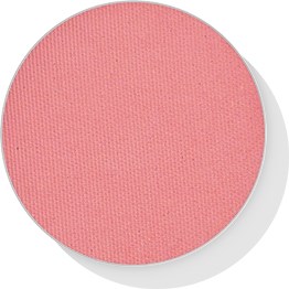 A round, pink textured surface, likely a makeup blush or cosmetic product.