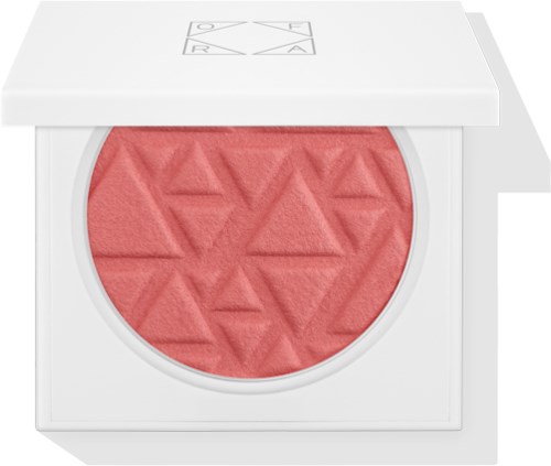 En blush med geometrisk mønster i en hvid compact-beholder.