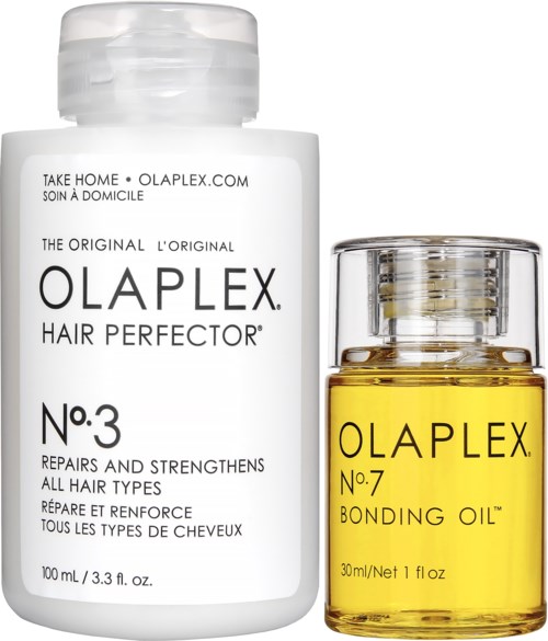 Twee kleine flessen haarproducten, één wit gelabeld 'Olaplex Hair Perfector No.3' en een gele 'Olaplex No.7 Bonding Oil.'