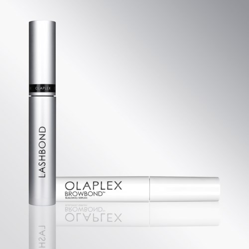 Two silver cylindrical bottles, one standing and one lying down, labeled Lash Bond and Olaplex Browbond.