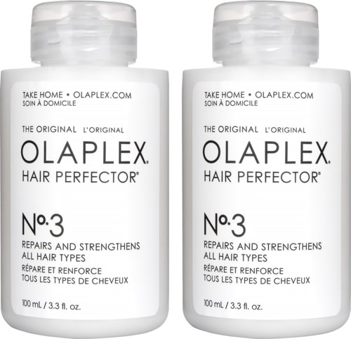 Två flaskor Olaplex No.3 Hair Perfector visas, som är utformade för att reparera och stärka håret. Vita flaskor med svart text.