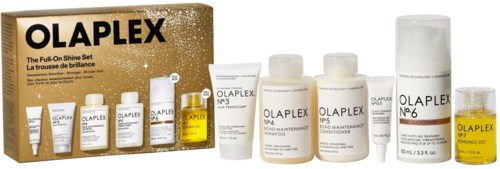 En hårvårdsset med flaskor av schampo, balsam och stylingprodukter från Olaplex, avsedda för hårreparation och glans.