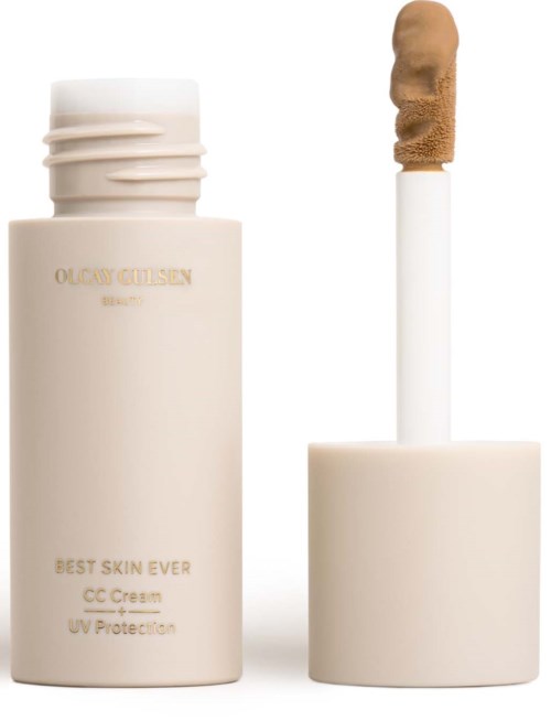 En beige flaska med hudvårdsprodukt och en applikatorstick som är redo att användas.