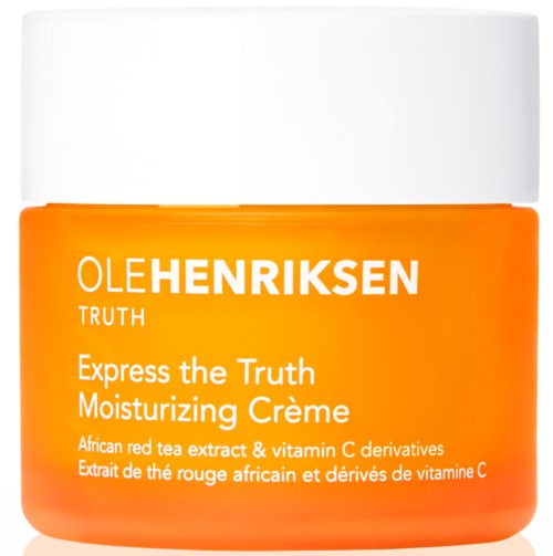 Ett orange- och vitt krus märkt Ole Henriksen, med text om återfuktande kräm och ingredienser som röd te och vitamin C.