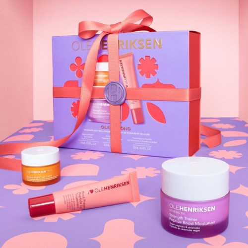 Beauty gift set with Ole Henriksen products, purple box, pink ribbon, and skincare jars and tubes.