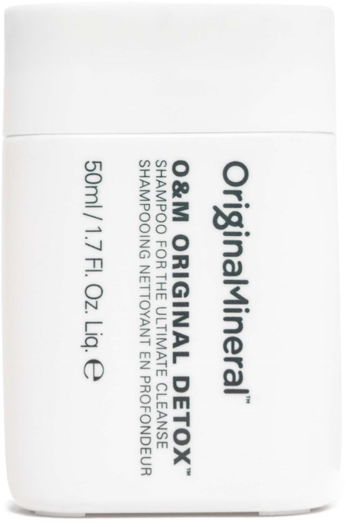 En liten vit flaska med svart text, märkt som original/herbal detox schampo, innehåller 50 ml eller 1,7 fl oz.