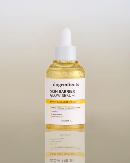 A small bottle of yellow serum with a white dropper cap, labeled 'Skin Barrier Glow Serum' and 'Barrier Care & Boost Glow'