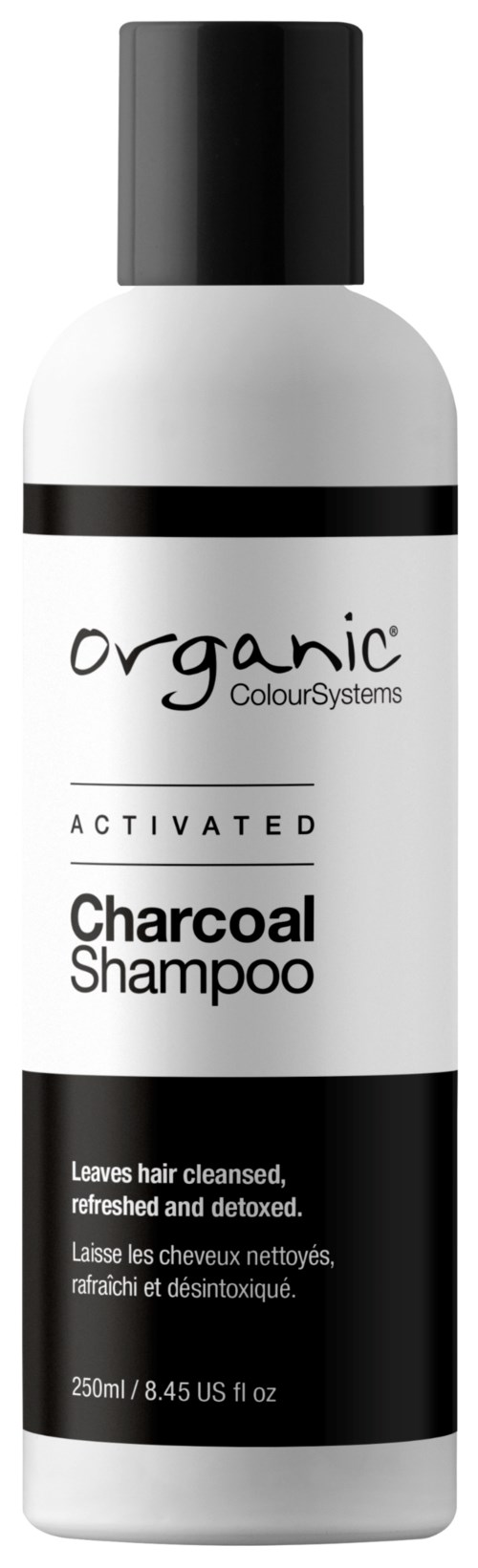 A white bottle with a black cap, labeled 'Organic Colour Systems Activated Charcoal Shampoo', for hair cleaning.
