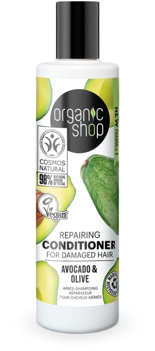 En hvit flaske med svart kork, avokado og olivenbilder, merket for å reparere skadet hår med veganske og naturlige ingredienser.