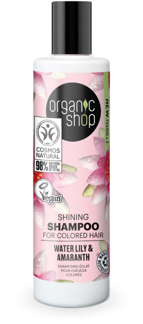 Valkoinen shampoo-pullo värjätylle hiuksille, kukkakuviolla ja mustalla korkilla, korostaa luonnollisia aineita ja vegaanisuutta.