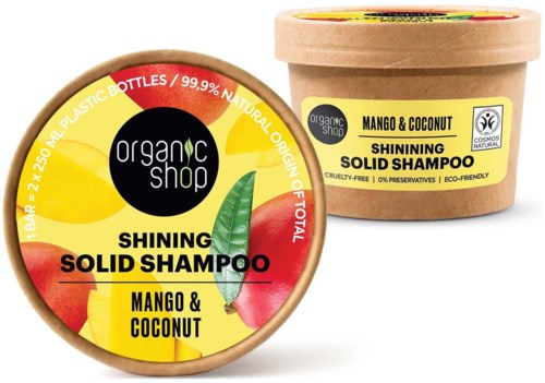 Etikett i rund form med gul bakgrunn og tekst om mango og kokos, satt på en krukke med sjampo.