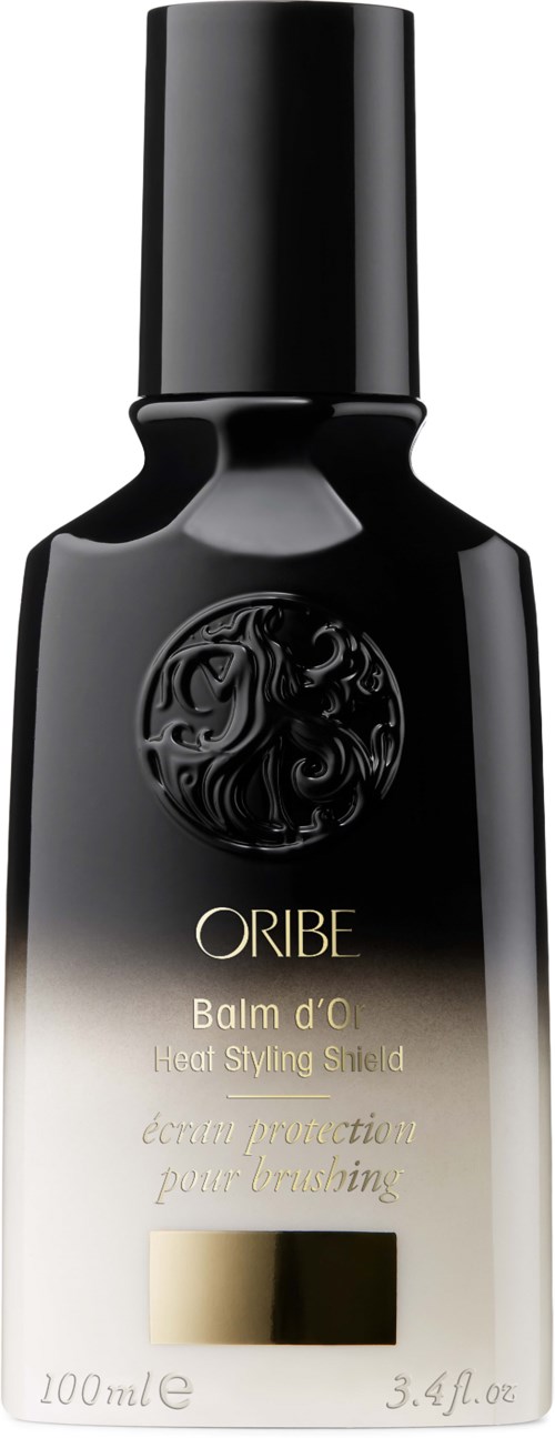 En svart og beige sprayflaske med gulldetaljer, merket ORIBE Balm d'O Heat Styling Shield, 100 ml.