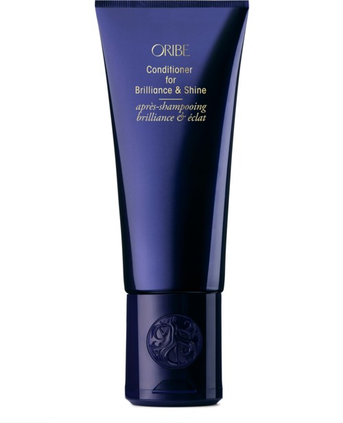 En mørkeblå tube med Oribe balsam for glans og glans, med gullfarget skrift og en logo nederst.
