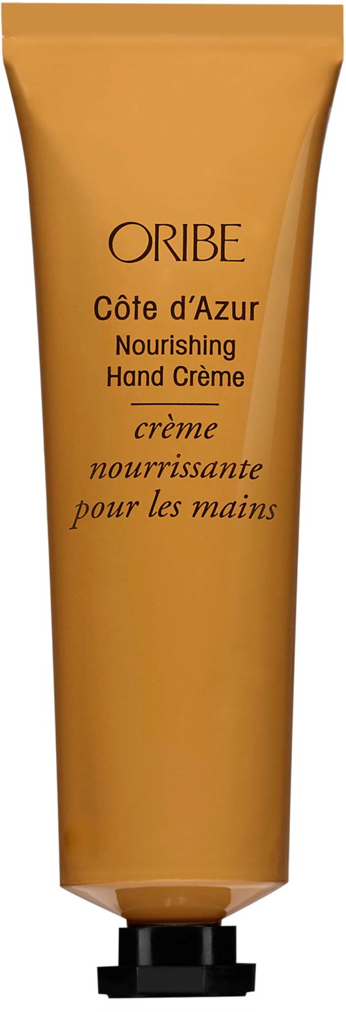 A beige tube of Oribe hand cream with black cap, labeled as nourishing and for hands.