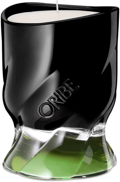 A candle holder with a black top and a green base, holding a white candle.