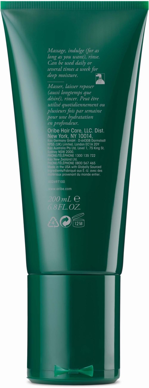 Green tube container with white text, likely a cosmetic or grooming product.