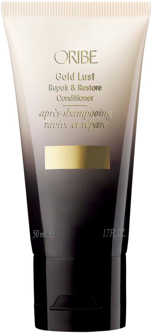 En tub märkt 'Oribe Gold Lust Repair & Restore Conditioner' med en gyllene rand, svart och beige färger.