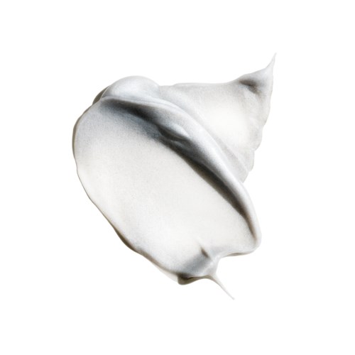 A swirl of white cream or lotion with a pointed tip and smooth texture. It is on a plain white background.