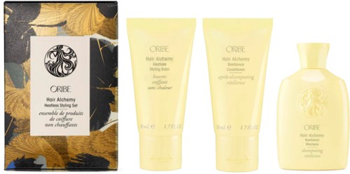 Fyra hårvårdsprodukter från Oribe, inklusive schampo, balsam och styling spray, i gula flaskor med svart och guld förpackning.