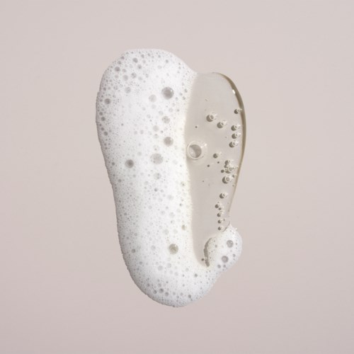 Soap with foam and bubbles on a light background.