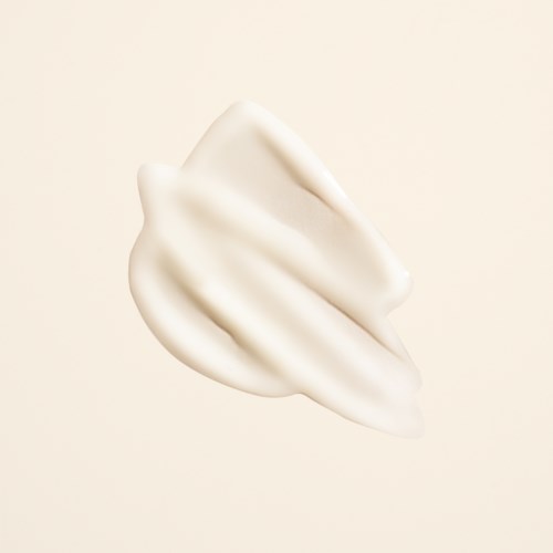 Een dot witte crème of lotion op een eenvoudige achtergrond.