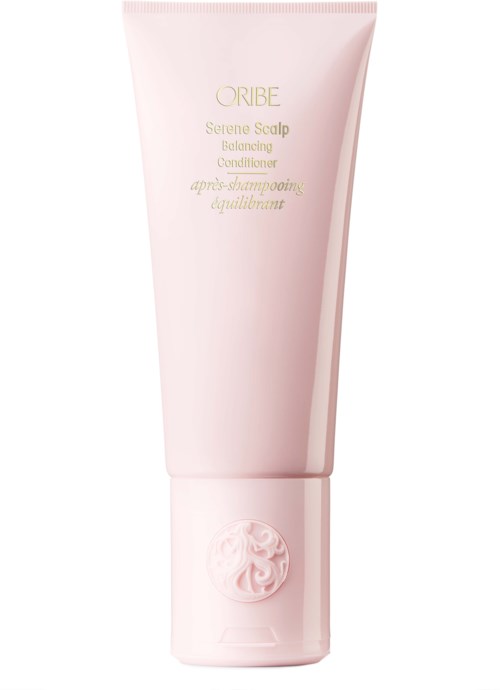 Pink tube of Oribe Scalp Rejuvenating Conditioner with gold and light pink text, and a raised logo at the bottom.