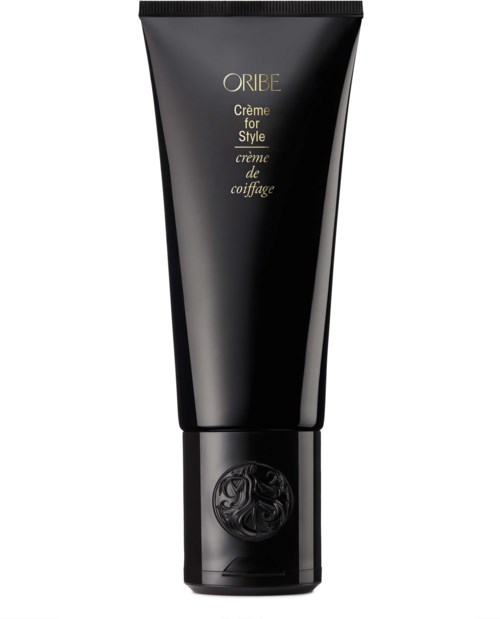 En svart tub med Oribe stylingkräm med guld- och svart text och en dekorativ logga nära botten.