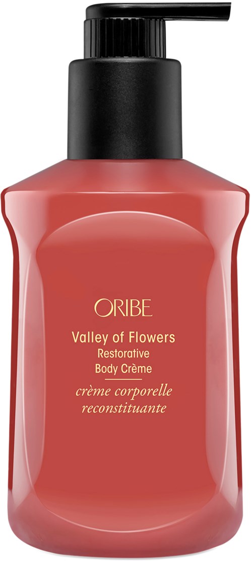 A pink bottle of Oribe Valley of Flowers Restorative Body Creme with black pump.