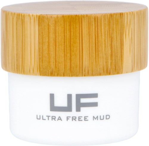 En liten vit behållare med ett trälock märkt 'ULTRA FREE MUD'.