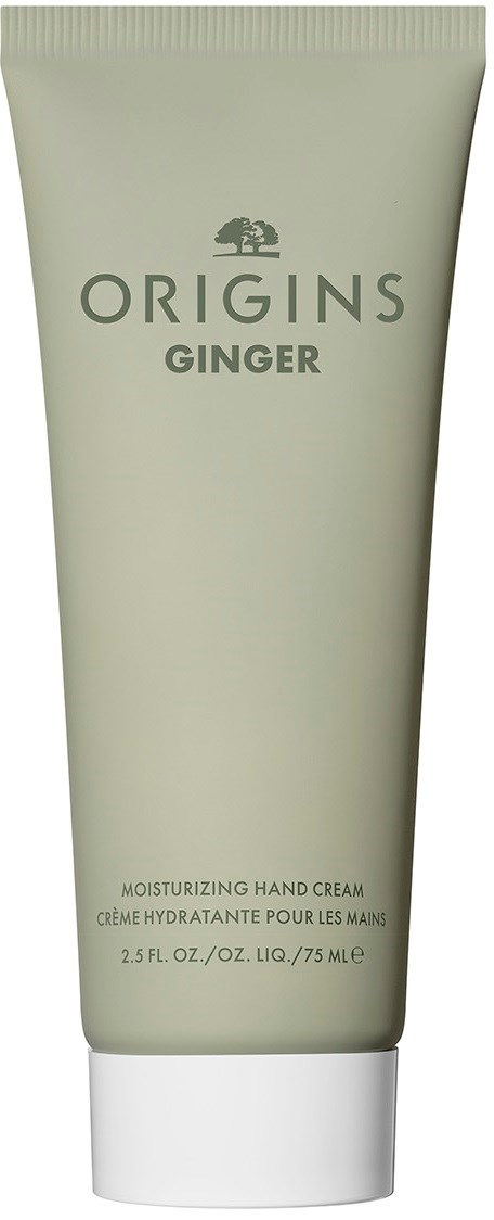 En grønn tube merket 'Origins Ginger' for fuktighetsgivende håndkrem, med hvit topp.