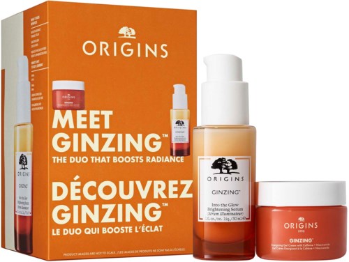 A bright orange box with skincare products for glowing skin, including serum and moisturizer, from Origins.