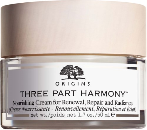 Een potje van Origins Three Part Harmony voedende crème voor vernieuwing, herstel en glans. Het heeft een beige deksel en een witte label.