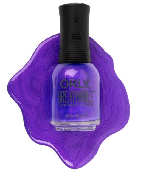 Purple nail polish bottle with the brand name 'Orly' on it, placed on purple spilled polish.