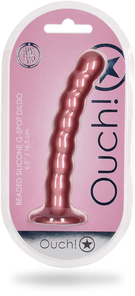 Vaaleanpunainen silikoninen dildo, teksturoitu pinta, pakkauksessa lukee "Ouch!" ja "Beaded Silicone."