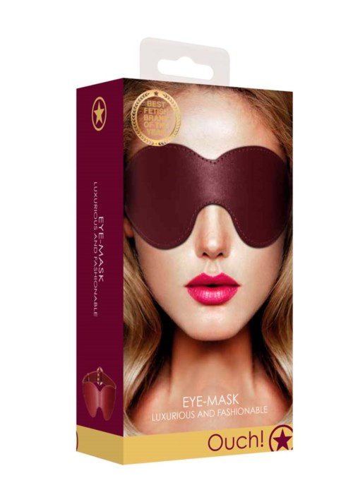 Verpakking van een modieus oogmasker, met een vrouw met rode lippen die een donkere oogbedekking draagt.