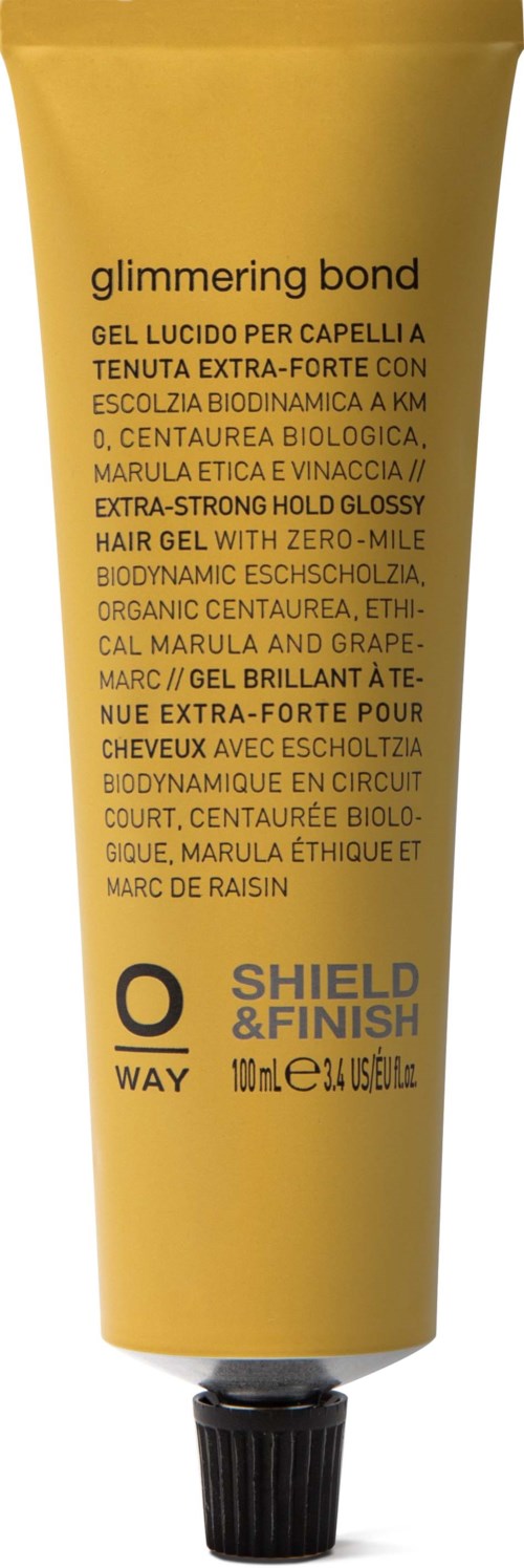 En gul tube med hårgelé merket 'Glimmering Bond' med ord om organiske og biologiske ingredienser.