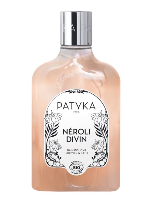 En genomskinlig flaska med silverlock, innehållande en rosa vätska märkt 'Patyka Neroli Divin' dusch- och badprodukt.