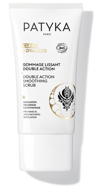 En vit tub av Patyka Paris ansiktsskrubb med svart och guld design, märkt för jämn och dubbelverkande peeling.