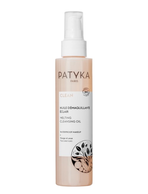En lång, ljusrosa flaska med smältande rengöringsolja och vit pump, märkt Patyká Paris för ansikte och ögonmakeup.