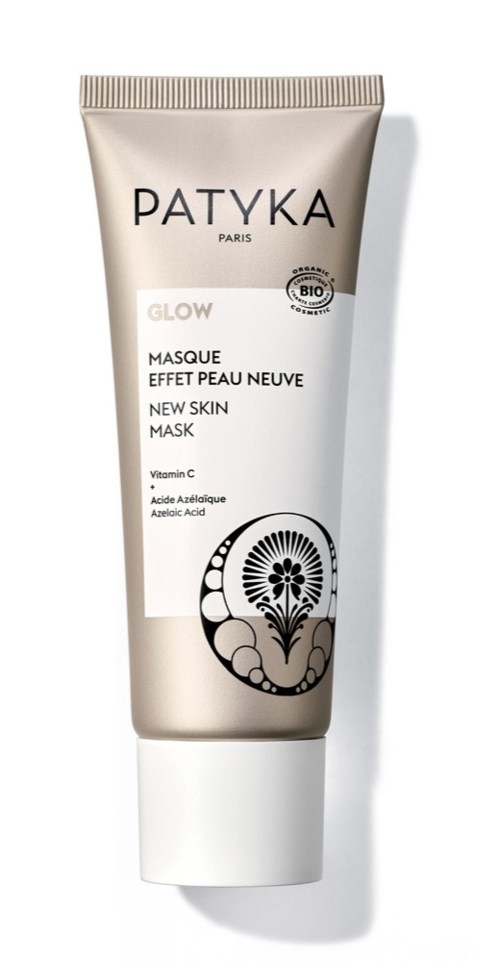 En tub med Patyka Glow ansiktsmask med vit och guld design, med produktdetaljer och en svart blomsterlogotyp.